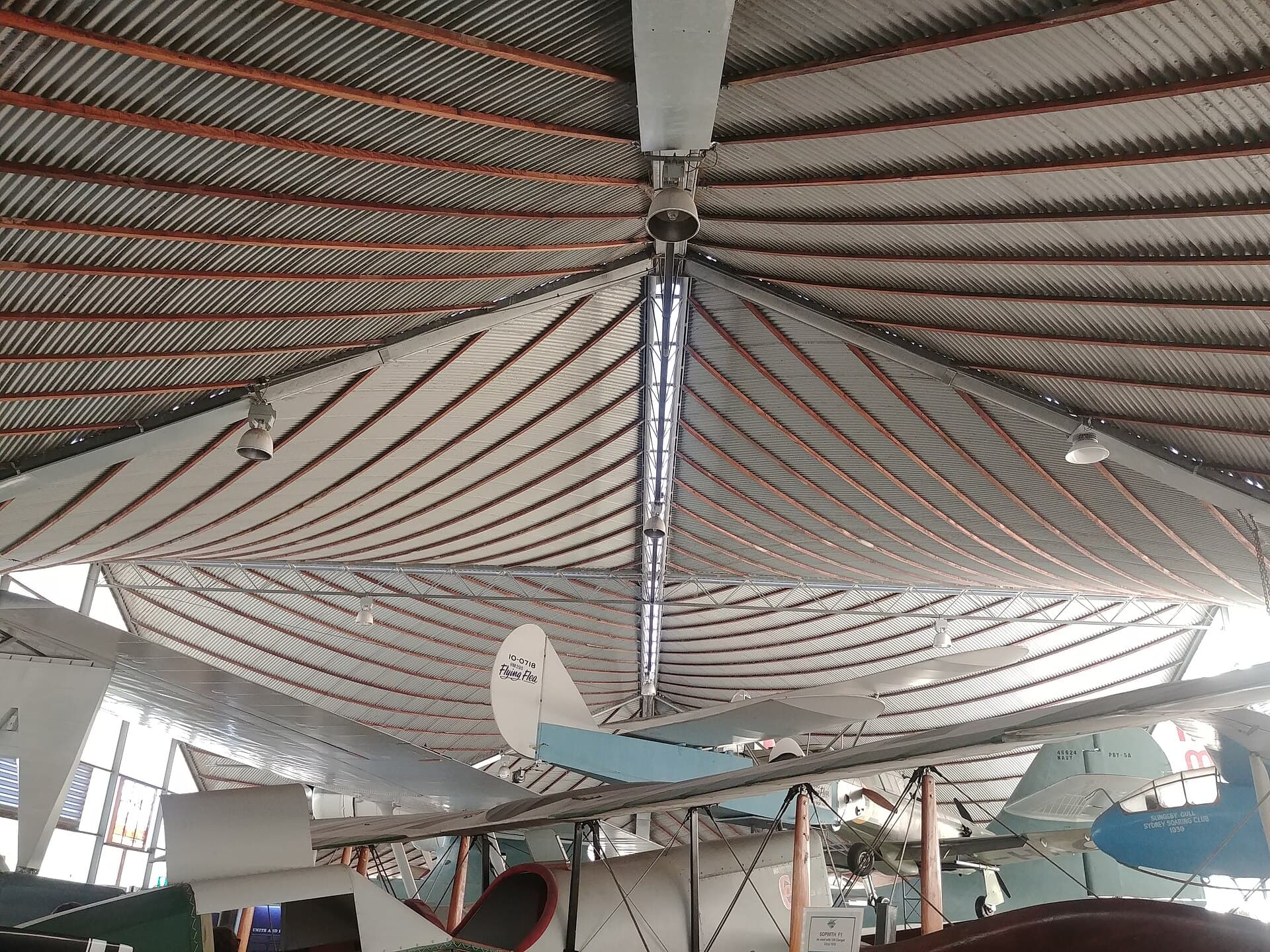 Interior view of a curved timber and corrugated-iron roof